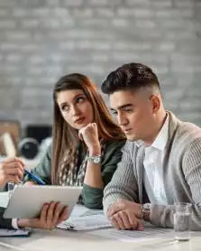 Experienced pharmacy consultants working on a blog article together